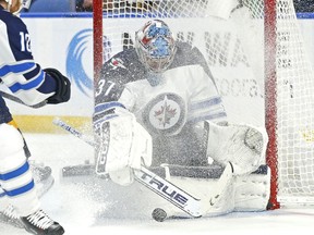Winnipeg Jets goalie Connor Hellebuyck (37) makes a save during the third period of an NHL hockey game against the Buffalo Sabres, Sunday, Feb. 10, 2019, in Buffalo N.Y.