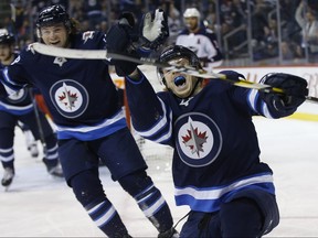 Winnipeg Jets' Mason Appleton (82), right, and Brendan Lemieux (48) celebrate Appleton's goal against the Columbus Blue Jackets during second period NHL action in Winnipeg on Thursday, January 31, 2019. THE CANADIAN PRESS/John Woods