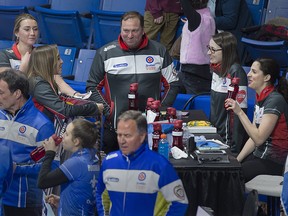Ontario coach Marcel Rocque, centre, talks with the team during the fifth-end break at the Scotties Tournament of Hearts at Centre 200 in Sydney, N.S. on Monday, Feb. 18, 2019. (THE CANADIAN PRESS/Andrew Vaughan)