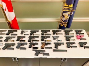 A pink handgun was among 25 firearms allegedly found stashed in the gas tank of a vehicle that attempted to cross the border into Canada at Fort Erie recently. (Toronto Police handout)
