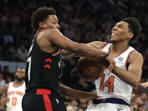 Raptors’ Kyle Lowry (left) tries to get the ball away from the Knicks’ Allonzo Trier in the Raptors’ win on Saturday. AP