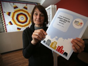 Lucille Bruce, CEO of End Homelessness Winnipeg, holds up the 2018 Winnipeg Street Health Survey Report, which was release to the public on Wednesday, Feb. 20, 2019. Chris Procaylo/Winnipeg Sun