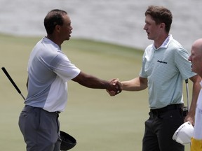 Tiger Woods shakes hands with Canadian Mackenzie Hughes on the 18th green during the third round of the Players Championship last May in Ponte Vedra Beach, Fla.  AP FILE