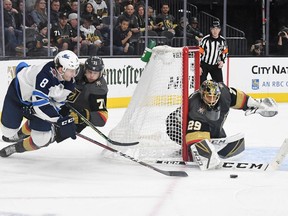 William Karlsson (71) and Marc-Andre Fleury (29) of the Vegas Golden Knights defend the net against Jacob Trouba (8) of the Winnipeg Jets in the third period of their game at T-Mobile Arena on Friday in Las Vegas