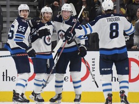 Mark Scheifele (55), Kyle Connor (81), Patrik Laine (29) and Jacob Trouba (8) of the Winnipeg Jets celebrate after Laine scored a second-period power-play goal against the Vegas Golden Knights during their game in Las Vegas on Friday.
