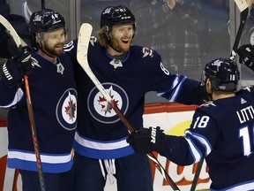 Winnipeg Jets forward Kyle Connor (centre) celebrates his game-winning goal late in the third period against the Columbus Blue Jackets with defenceman Josh Morrissey (left) and centre Bryan Little in Winnipeg on Thurs., Jan. 30, 2019. Kevin King/Winnipeg Sun/Postmedia Network