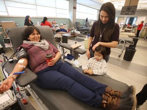 Teresa gives blood while Miranda McLeod and Tanner McLeod keep her company. Five-year-old Tanner needs a stem cell transplant, At six months old, Tanner was diagnosed with a rare form of anemia called sideroblastic anemia.