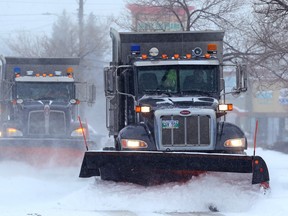 Plows clear Roblin Boulevard near McLean Street in Winnipeg on Monday.