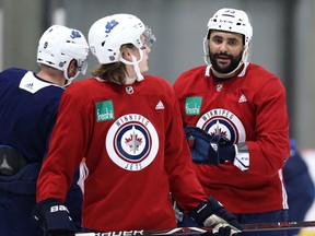 Dustin Byfuglien (right) speaks with Sami Niku during Winnipeg Jets practice at Bell MTS iceplex in Winnipeg on Mon., Feb. 4, 2019. Kevin King/Winnipeg Sun/Postmedia Network