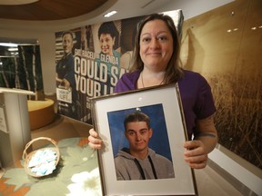 Lisa Boyd holds a photo of her deceased son Tyler Klassen at an event where data regarding the impact the  previous year's organ donations was announced.  The families and deceased donors were honoured.  Wednesday February 13/2019 Winnipeg Sun/Chris Procaylo/stf