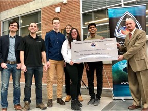 Wayne Ellis of the Canadian Satellite Design Challenge (far right) presents the cheque to Sanjay Abraham (second from right) and other members of the University of Manitoba Space Applications and Technology Society (UMSATS) team on Monday.