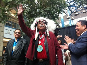 Joseph Meconse raises his hand in triumph flanked by Manitoba Deputy Premier Eric Robinson (left) and Assembly of First Nations grand chief Perry Bellegrande following a press conference at Portage Place mall in Winnipeg on Friday, March 11, 2016. Meconse died Sunday. He was 77.