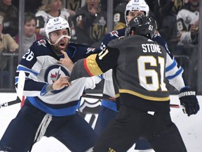 Blake Wheeler of the Winnipeg Jets and Mark Stone of the Vegas Golden Knights fight in the first period of their game at T-Mobile Arena in Las Vegas on Thursday night.  (Photo by Ethan Miller/Getty Images)