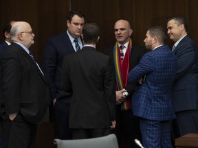 Liberal MPs and staffers gather and speak before a meeting of the justice committee in Ottawa on March 19, 2019. (THE CANADIAN PRESS)