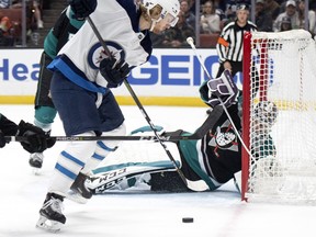 Anaheim Ducks goaltender John Gibson defends the goal againstWinnipeg Jets winger Kyle Connor during Wednesday's game. (AP PHOTO)