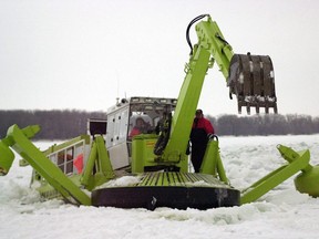 An amphibex prepares river ice for break up.