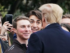 US President Donald Trump chats with guests viewing his departure from the South Lawn of the White House in Washington, DC on March 22, 2019.