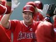 In this Sept. 10, 2017, file photo, Los Angeles Angels' Mike Trout is greeted in the dugout after hitting a solo home run in the first inning of a baseball game against the Seattle Mariners in Seattle. (AP Photo/Ted S. Warren, File)
