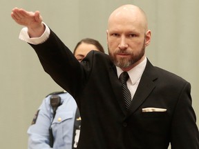 Anders Behring Breivik raises his right hand at the start of his appeal case in Borgarting Court of Appeal at Telemark prison in Skien, Norway, Tuesday, Jan. 10, 2017.