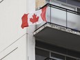 In this Sept. 28, 2011 file photo, a Canadian flag is seen flying from the balcony of an apartment building in Ottawa. (Andre Forget/Postmedia Network files)