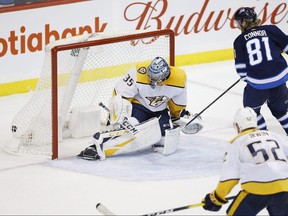 Winnipeg Jets' Kyle Connor scores his second goal of the game against Nashville Predators goaltender Pekka Rinne last night. The Jets won 5-0. (The Canadian Press)