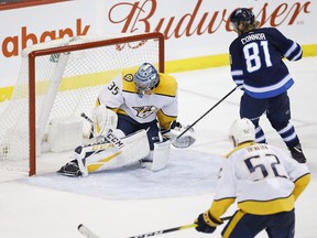 Winnipeg Jets' Kyle Connor scores his second goal of the game against Nashville Predators goaltender Pekka Rinne last night. The Jets won 5-0. (The Canadian Press)