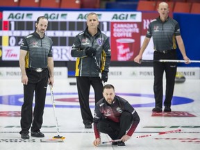 Team New Brunswick skip Terry Odishaw, lead Grant Odishaw and second Marc Lecocq look on as Team Canada skip Brad Gushue watches his shot during the 10th draw at the Brier in Brandon, Man. Tuesday, March 5, 2019. THE CANADIAN PRESS/Jonathan Hayward ORG XMIT: JOHV165