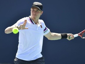 Denis Shapovalov returns a volley to Daniel Evans during the Miami Open, in Miami Gardens, Fla., on Saturday, March 23, 2019.