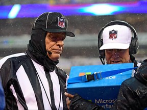 Field judge Tom Hill, left, and referee Shawn Hochuli review a New York Giants punt in which they challenged during the first half against the Tennessee Titans at MetLife Stadium on Dec. 16, 2018 in East Rutherford, N.J. (Steven Ryan/Getty Images)