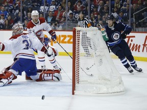 Winnipeg Jets' Patrik Laine's shot rings off the post behind Montreal Canadiens goaltender Carey Price  last night at Bell MTS Place. (The Canadian Press)