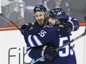 Winnipeg Jets' Kevin Hayes (12) and Mark Scheifele (55) celebrate Hayes' his first goal for the Jets since his recent trade to the team during third period NHL action against the Nashville Predators, in Winnipeg on Friday, March 1, 2019.