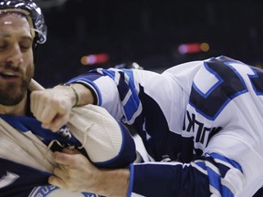 Winnipeg Jets' Dmitry Kulikov, of Russia, right, lands a punch on Columbus Blue Jackets' Nick Foligno during the second period of an NHL hockey game Sunday, March 3, 2019, in Columbus, Ohio.