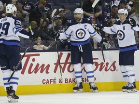 Winnipeg Jets' Blake Wheeler, center, celebrates his goal against the Columbus Blue Jackets with teammates Patrik Laine, left, of Finland, and Mark Scheifele during the third period of an NHL hockey game Sunday, March 3, 2019, in Columbus, Ohio. The Jets beat the Blue Jackets 5-2.