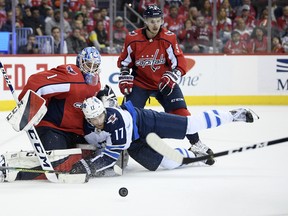 Winnipeg Jets' Adam Lowry collides into Capitals goaltender Pheonix Copley during the second period in Washington on Sunday night. The Caps won 3-1 AP Photo/Nick Wass