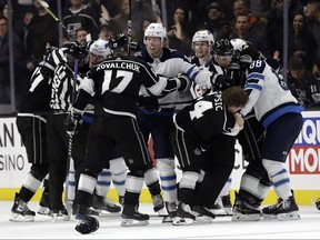 Players from the Jets and Kings get into a scuffle during the second period in Los Angeles last night.  Marcio Jose Sanchez/AP