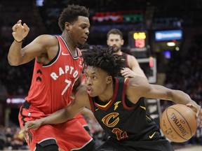 Cavaliers' Collin Sexton (right) drives past Raptors' Kyle Lowry (left) during first half NBA action in Cleveland, Monday, March 11, 2019.