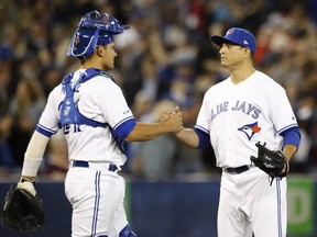 Catcher Luke Maile (left) celebrates the Jays’ win over Detroit with reliever Javy Guerra on Friday. THE CANADIAN PRESS