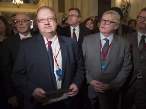 Manitoba Health Minister Kelvin Goertzen, (centre left), Quebec Health Minister and Social Services Gaetan Barrette (centre right) and other provincial health ministers wait to speak as a group before a meeting with the federal finance and health ministers in Ottawa, Monday December 19, 2016. The Manitoba government will be getting advice on education reform from a consultant who recently prompted Nova Scotia to eliminate elected school boards and make other sweeping changes.