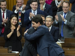 Prime Minister Justin Trudeau embraces Finance Minister Bill Morneau following the delivery of the federal budget in the House of Commons in Ottawa, Tuesday March 19, 2019.