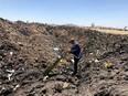 In this photo taken from the Ethiopian Airlines Facebook page, the CEO of Ethiopian Airlines, Tewolde Gebremariam, looks at the wreckage of the plane that crashed shortly after takeoff from Addis Ababa, Ethiopia, Sunday March 10, 2019.