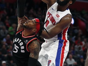 Detroit Pistons center Andre Drummond dunks on Toronto Raptors forward Eric Moreland in Detroit on Sunday. (AP)