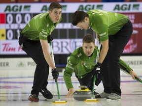 Saskatchewan skip Kirk Muyres throws a stone while Daniel Marsh (left) and Dallan Muyres sweep during weekend action the 2019 Brier in Brandon, Manitoba.