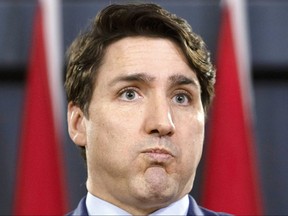 Prime Minister Justin Trudeau grimaces as he holds a news conference in Ottawa, Thursday March 7, 2019. THE CANADIAN PRESS/Fred Chartrand ORG XMIT: FXC102