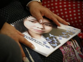 Sagkeeng councillor Marilyn Courchene holds the report as Daphne Penrose, the Manitoba Advocate for Children and Youth, releases a special report on the death of fifteen year old Tina Fontaine at a release event at the Sagkeeng Mino Pimatiziwin Family Treatment Centre on the Sagkeeng First Nation, Man., Tuesday, March 12, 2019. THE CANADIAN PRESS/John Woods