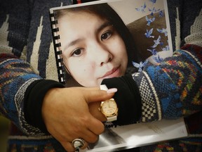 Sagkeeng councillor Marilyn Courchene holds the report as Daphne Penrose, the Manitoba Advocate for Children and Youth, releases a special report on the death of fifteen year old Tina Fontaine at a release event at the Sagkeeng Mino Pimatiziwin Family Treatment Centre on the Sagkeeng First Nation, Man., Tuesday, March 12, 2019. THE CANADIAN PRESS/John Woods