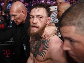 In this Oct. 6, 2018, file photo, Conor McGregor walks out of the arena after he was defeated by Khabib Nurmagomedov in a lightweight title mixed martial arts bout at UFC 229 in Las Vegas. Superstar UFC fighter McGregor has announced on social media that he is retiring from mixed martial arts. McGregor's verified Twitter account had a post early Tuesday, March 26, 2019, that said the former featherweight and lightweight UFC champion was making a "quick announcement."