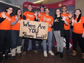 The 5 Days for the Homeless sleepers pose with Resource Assistance for Youth communications assistant Kate Armstrong (third from right) after the opening ceremonies for the national event at Asper School of Business on the University of Manitoba campus on Sunday.