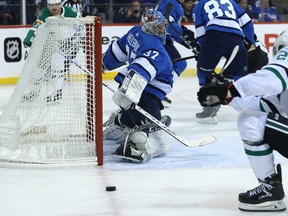 Winnipeg Jets goaltender Connor Hellebuyck slides across his crease as Dallas Stars forward Brett Ritchie is unable to get a shot on goal on Monday night.  Kevin King/Winnipeg Sun/Postmedia Network