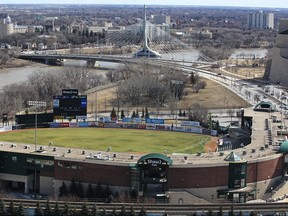 Shaw Park (foreground) and the Provencher Bridge and Esplanade Riel as seen from the roof of the Fairmont Hotel in Winnipeg. The Goldeyes will being play on their home field in August after nearly two seasons away. Kevin King/Winnipeg Sun/Postmedia Network