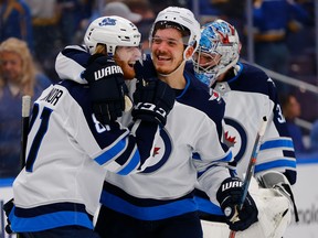 Jets' Kyle Connor is congratulated by Jack Roslovic after scoring the game-winning goal in overtime against the St. Louis Blues in Game Four of the Western Conference first round in St. Louis on Tuesday night. (Photo by Dilip Vishwanat/Getty Images)